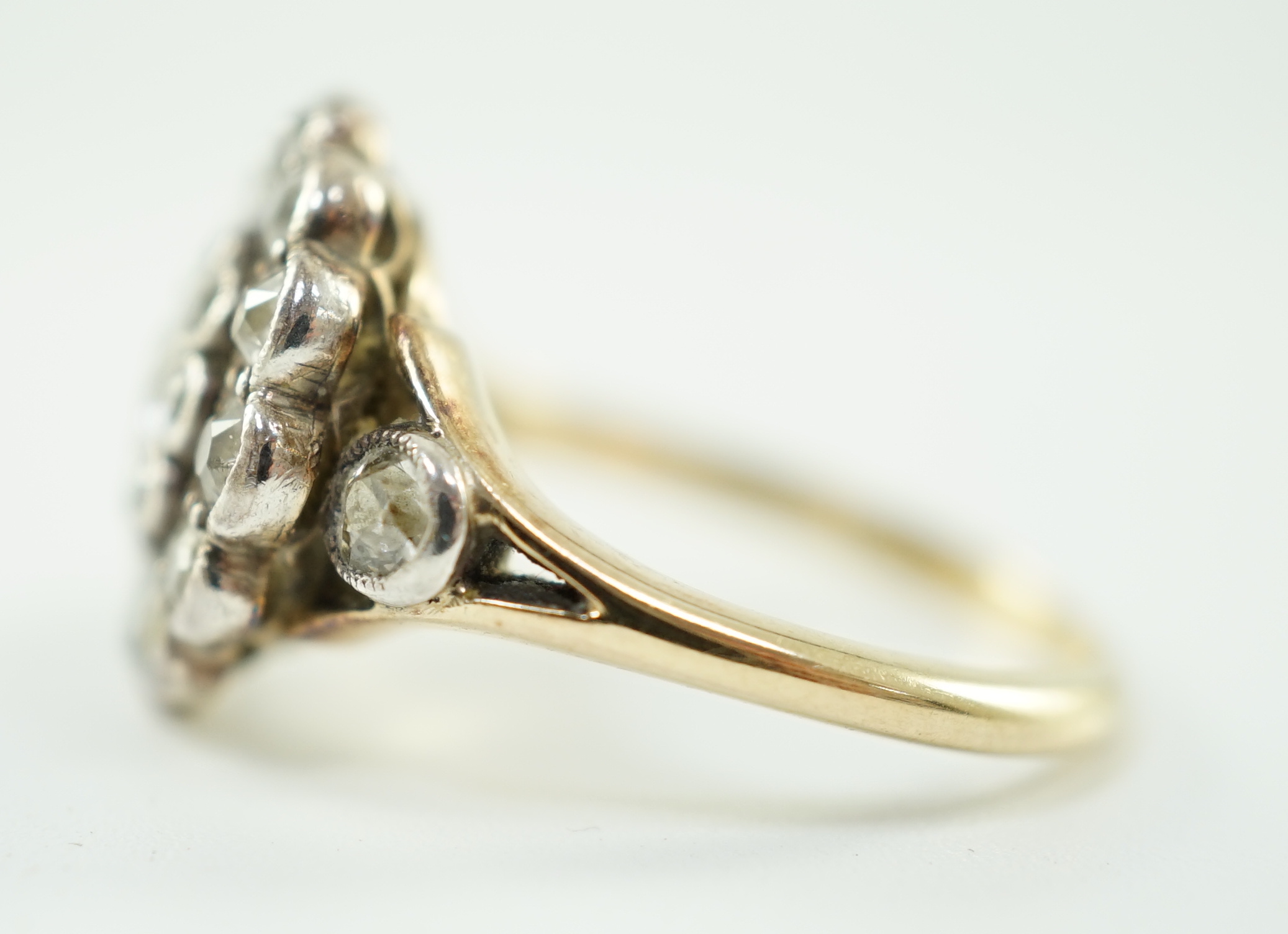 A mid 20th century gold and millegrain set diamond cluster target ring